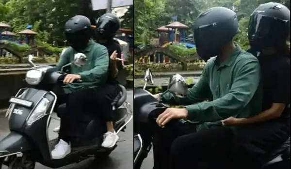 Viral Video: हाथ में छतरी, ब्लैक हेल्मेट में छिपा मुंह, आखिर कौन हैं ये लव बर्ड्स?